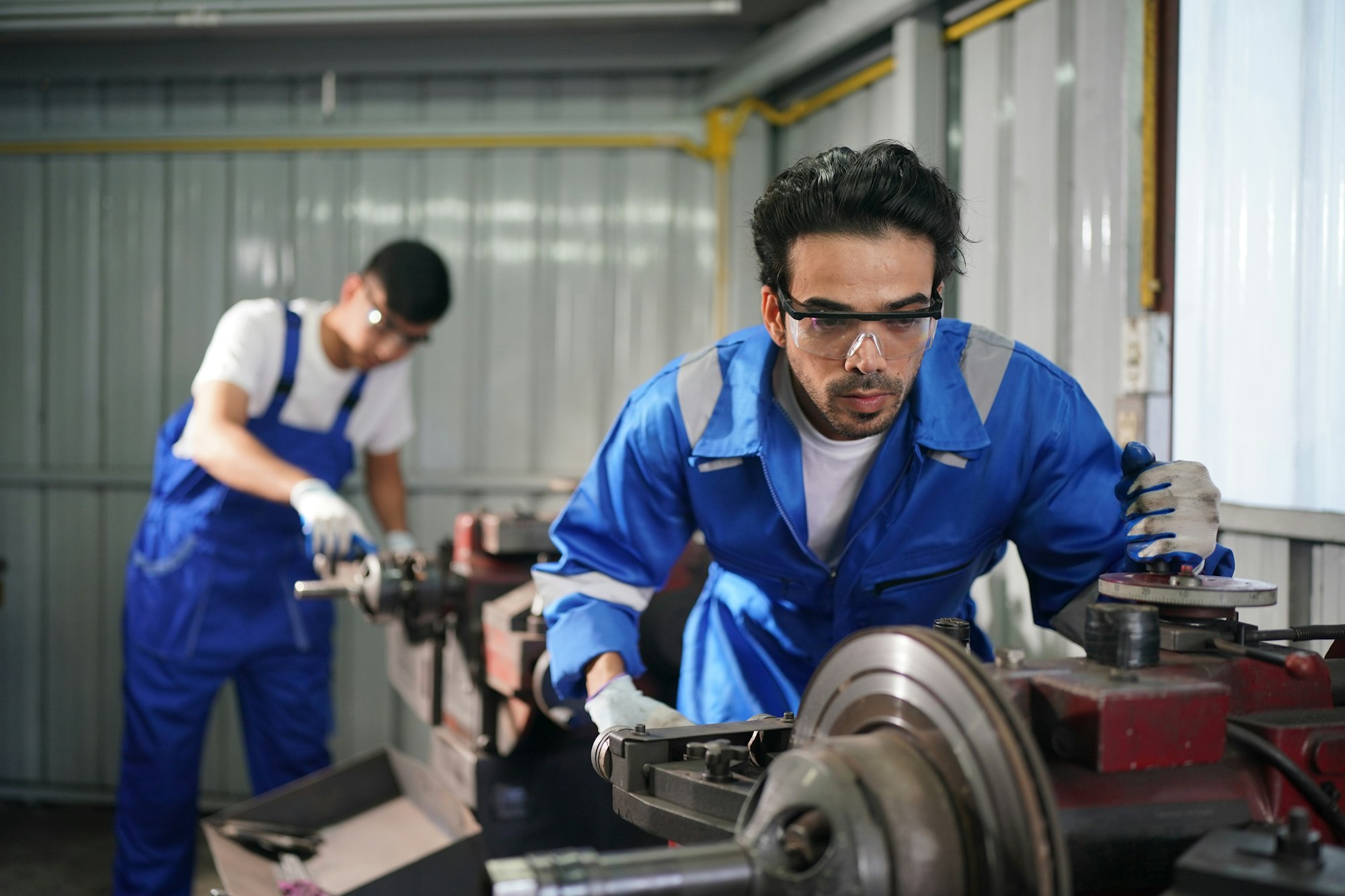 Auto mechanics making wheel alignment at the car service