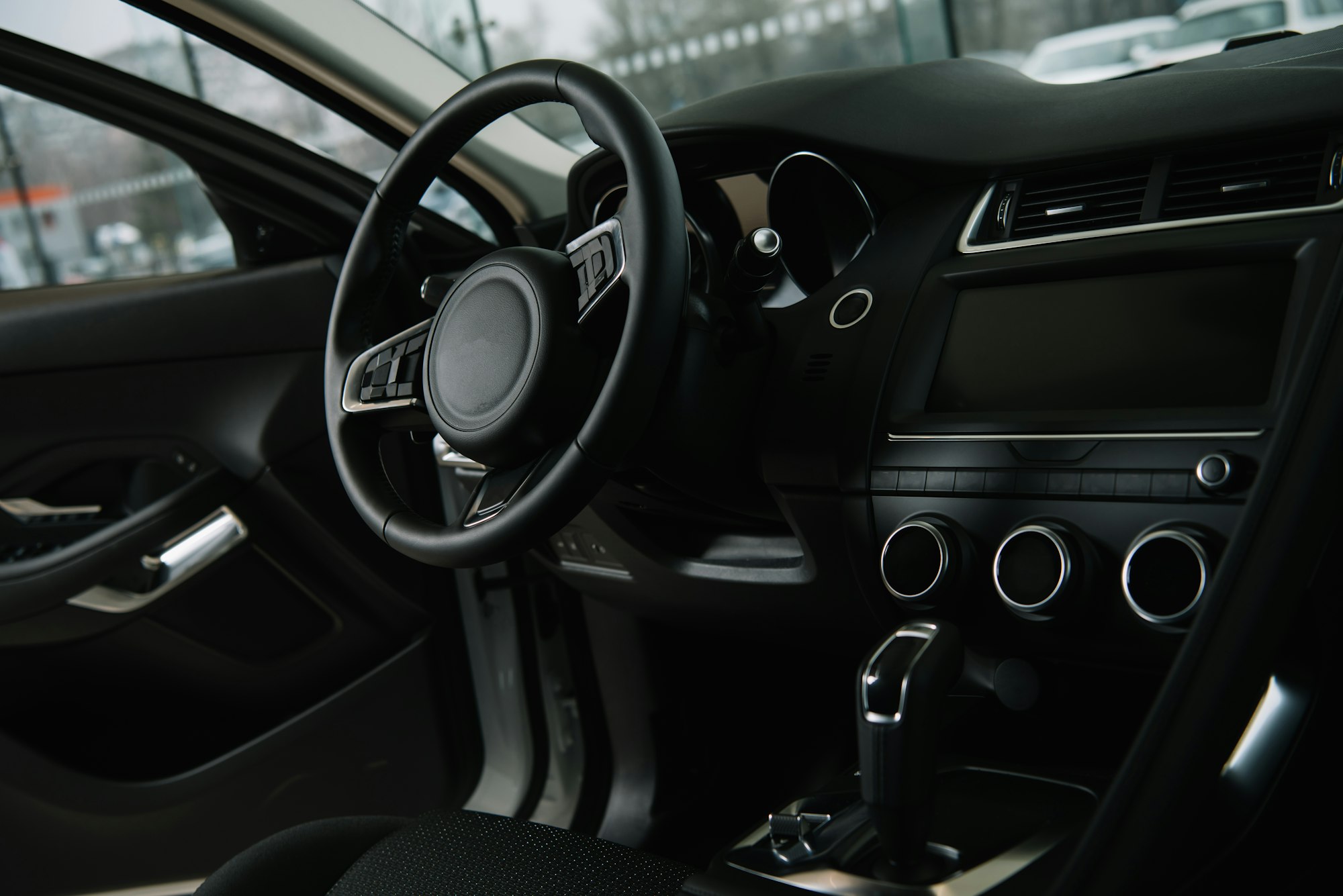 black steering wheel near manual transmission in luxury car