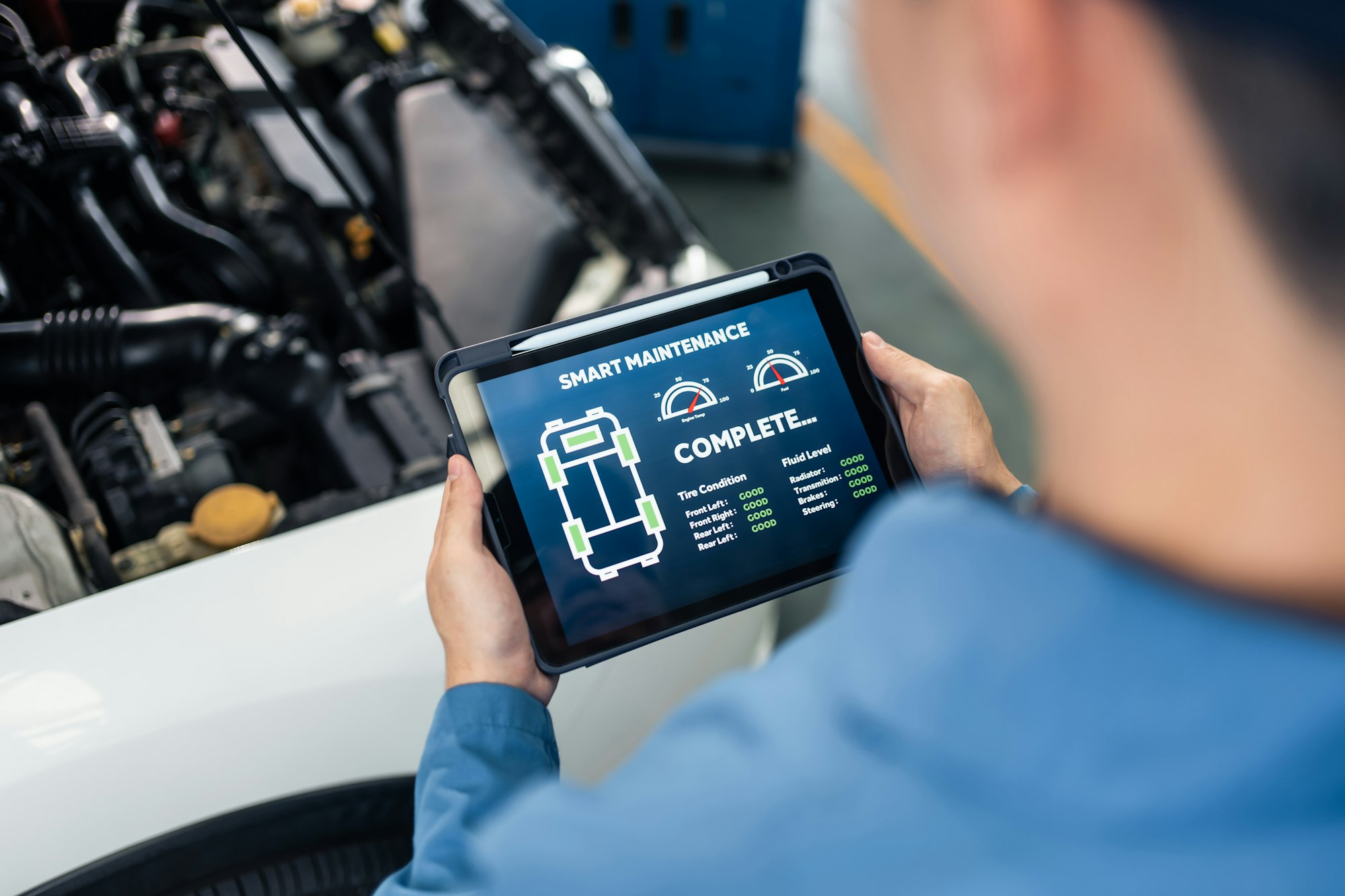 Close up of Automotive mechanic running diagnostics software on tablet.