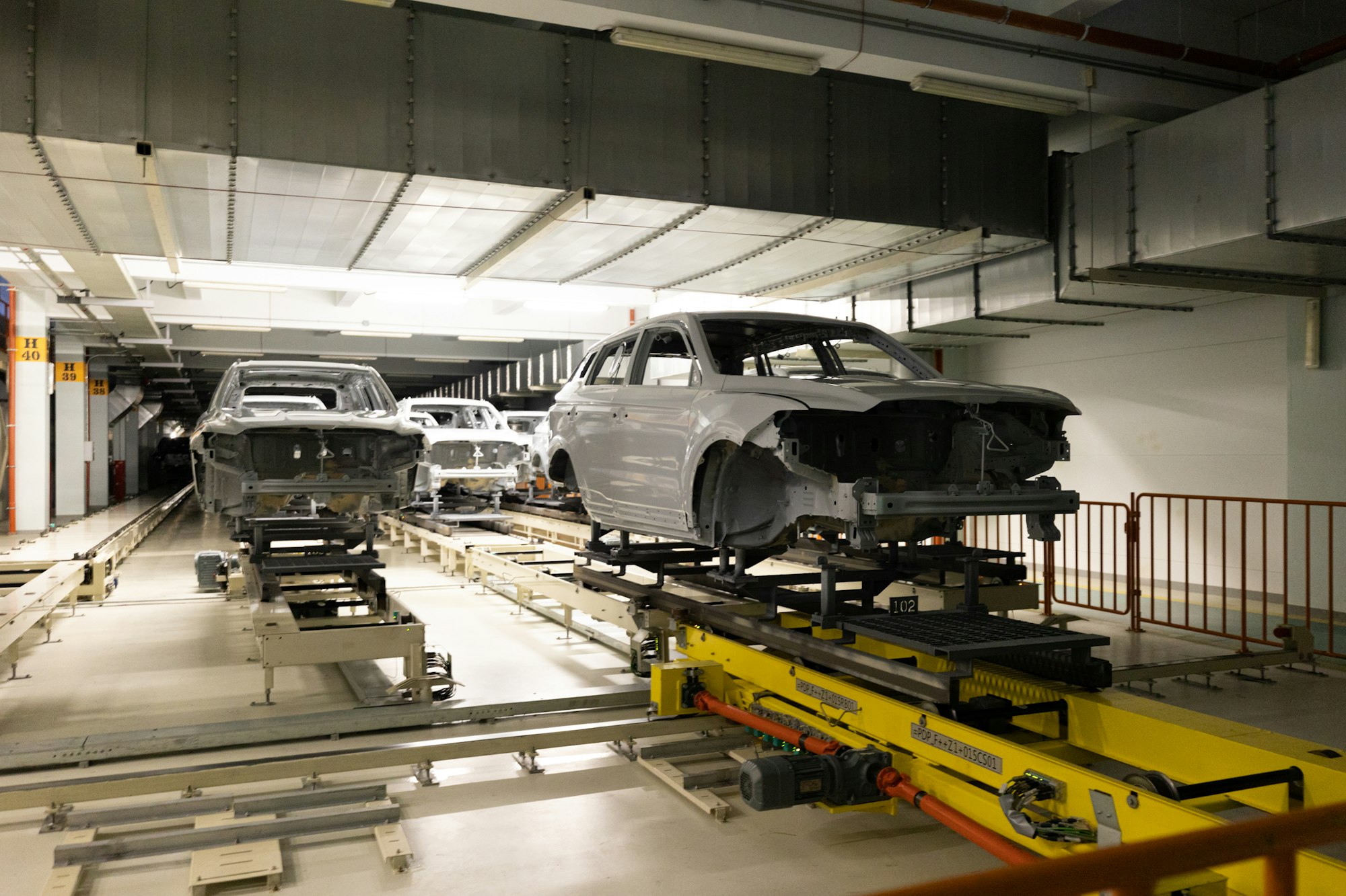 Car bodies are on assembly line. Modern automotive industry. Automobile conveyor. Interior of