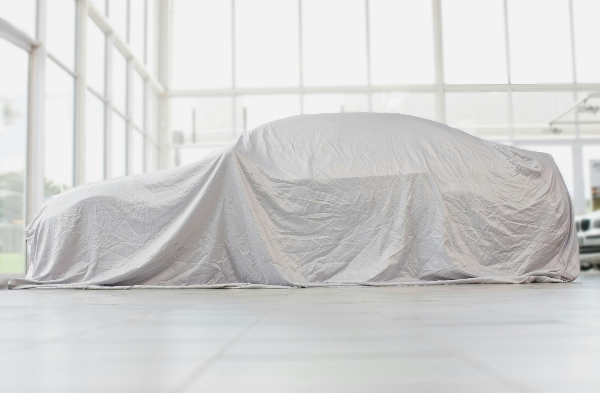 Car covered in cloth in garage